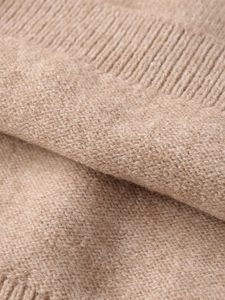 Detailed close-up of premium camel knit fabric showing soft texture and ribbed edges