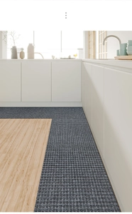Macro detail of dark grey grid textured kitchen mat with anti-slip and oil-resistant finish