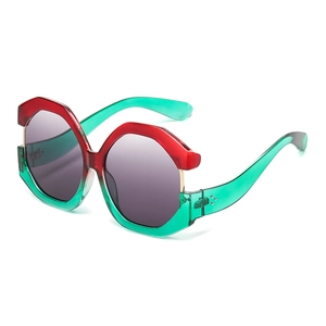Oversized cat-eye sunglasses with red and green color-block geometric frames and grey lenses