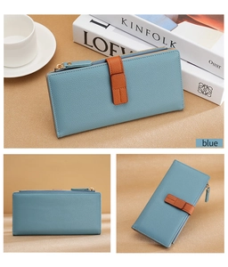 Detail view of long blue leather wallet with brown strap and gold zipper accents