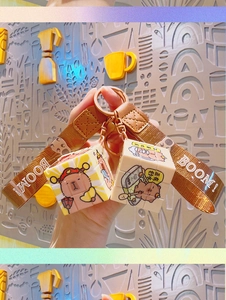Close-up of brown strap and beige mini cube pendant with Kapibara cartoon illustration