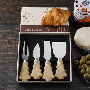 Detail of Christmas tree shaped wooden handles on stainless steel cheese knife set