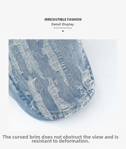 Detail view of washed denim beret featuring distressed ripped brim and curved peak design