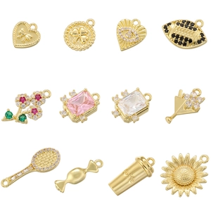 Detailed grid view of 12 distinct gold-plated charms including heart, clover, and cup designs