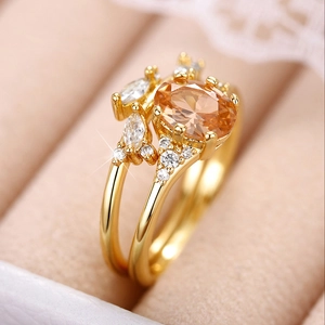 Macro detail of champagne oval gemstone and leaf-shaped marquise stones on gold ring