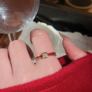 Close-up of gold-plated red enamel ring with a square zircon in a vintage style