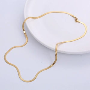 3mm flat gold snake bone chain necklace displayed on a white ceramic plate