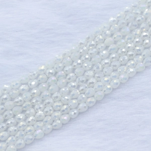 Macro detail of faceted milky white strawberry teardrop beads for DIY jewelry making