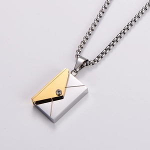 Macro detail of envelope pendant necklace with polished metal and sparkling zircon stone