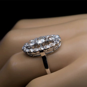 Macro side view of luxury oval cluster engagement ring with shimmering cubic zirconia