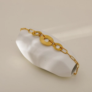 Elegant gold-plated stainless steel chain bracelet with textured round charms on ceramic base