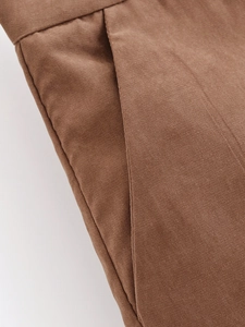 Detail view of the brown twill fabric pocket on a stylish minimalist blazer