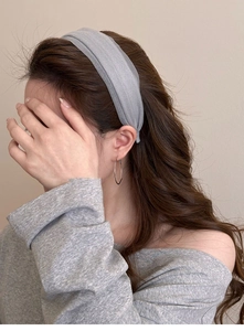 Detail showing elegant grey silk gauze headband texture and matching metal hoop earrings
