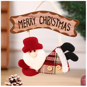 Detail of Santa Claus hanging ornament with Merry Christmas sign and plaid fabric accents
