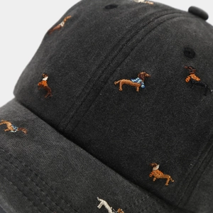 Close-up of vintage washed cotton baseball cap with colorful dachshund dog embroidery