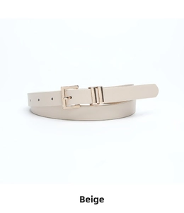 Detail of beige skinny belt featuring a golden square buckle and smooth leather texture