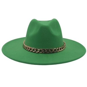 Detail of green wool fedora hat featuring a bold gold acrylic chain and flat brim