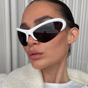 Close-up of futuristic Y2K white wrap-around sunglasses worn by a model in detail