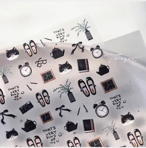 Detailed macro view of TS-4007 black cat diary embossed nail art stickers on a ceramic tray