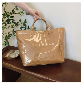 Close-up of a brown DuPont paper tote bag with TOTE BAG print on wooden background