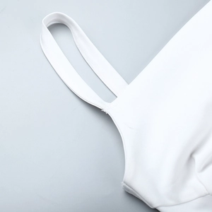 Close-up detail of white dress shoulder strap stitching and smooth high-quality fabric