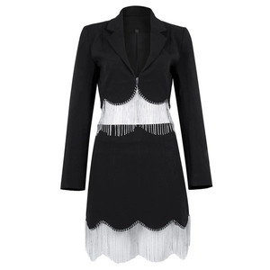Detail of black blazer dress featuring sparkling silver rhinestone fringe on waist and hem