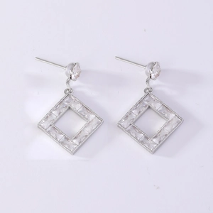 Macro detail of silver geometric square earrings with sparkling cubic zirconia inlay