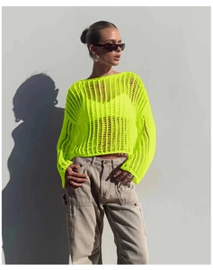 Detail of neon green crochet knit texture and hollow-out mesh on beach cover-up sleeve
