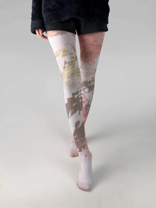 Detail shot of sheer patterned tights with abstract geometric tie-dye print on legs