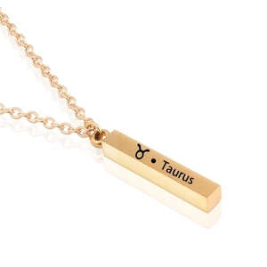 Macro view of gold Taurus zodiac bar pendant necklace in polished stainless steel