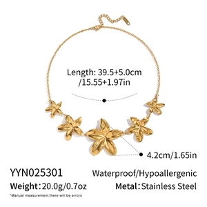 Detail of waterproof stainless steel necklace with gold plumeria flower pendants