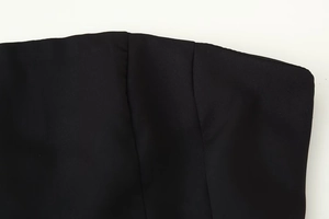 Close-up of the black strapless top showing fabric texture and fine stitching detail