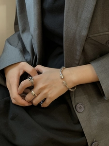Close-up of vintage silver cuff bracelet with bud ends and embossed cross rings