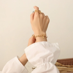 Gold OT clasp pearl bracelet with square tag and stackable rings for women
