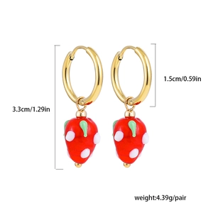 Detailed view of red strawberry pendants on golden hoops with size and weight metrics