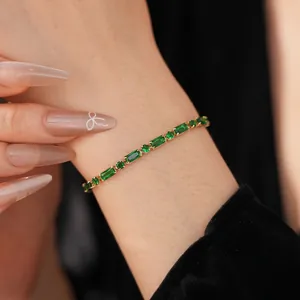 Exquisite 18K gold plated tennis bracelet with emerald green zircon stones on wrist