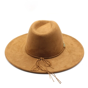 Detail of brown wide brim fedora hat with turquoise beads and string tassel decoration