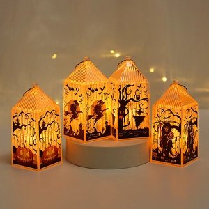 Close-up of four orange LED Halloween lanterns with black classic spooky silhouettes