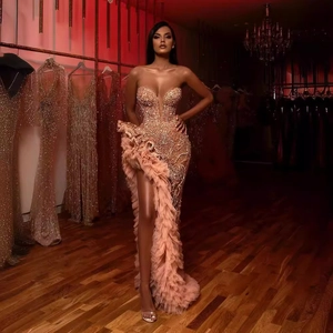 Rose gold sequined off-shoulder evening gown with tiered fringe and high slit detail