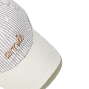 Detailed macro of striped preppy baseball cap with premium 3D embroidered amis text