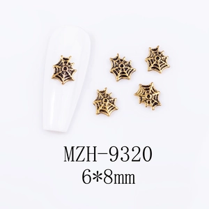 Macro shot of 6x8mm vintage gold spider web charms for 3D nail art decoration