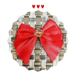 Red silk bow hair accessory with a sparkling square rhinestone on checkered background