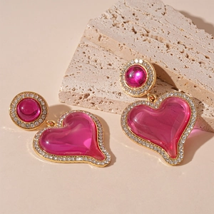 Exaggerated rose pink resin heart earrings with gold rhinestone borders for women