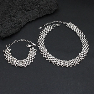 Detail of silver-toned braided stainless steel necklace set with lobster clasp and chain