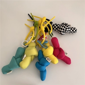Colorful knotted fabric bag charms with silicone beads and vibrant checkerboard patterns