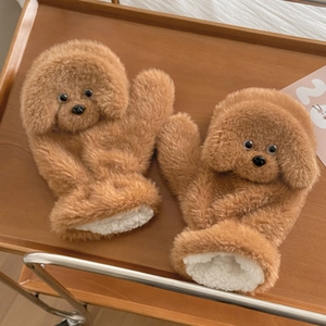 Close-up of thick plush teddy dog mittens with warm white fleece lining and soft texture