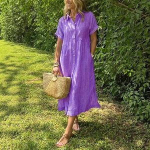 Short sleeve purple striped cotton linen shirt dress for women in a sunny garden setting