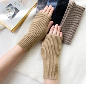 Detailed knit texture of khaki fingerless gloves for winter warmth and typing