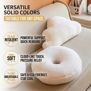 White plush heart and cloud shaped cushions made of faux rabbit fur on a beige sofa
