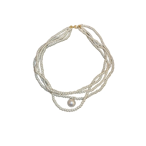 Baroque multi-layer pearl necklace with a large white pearl drop and gold lobster clasp